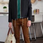 Male model navy jacket, green sweater, brown pants
