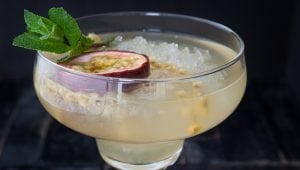 Exotic cocktail with fresh passionfruit on crushed ice